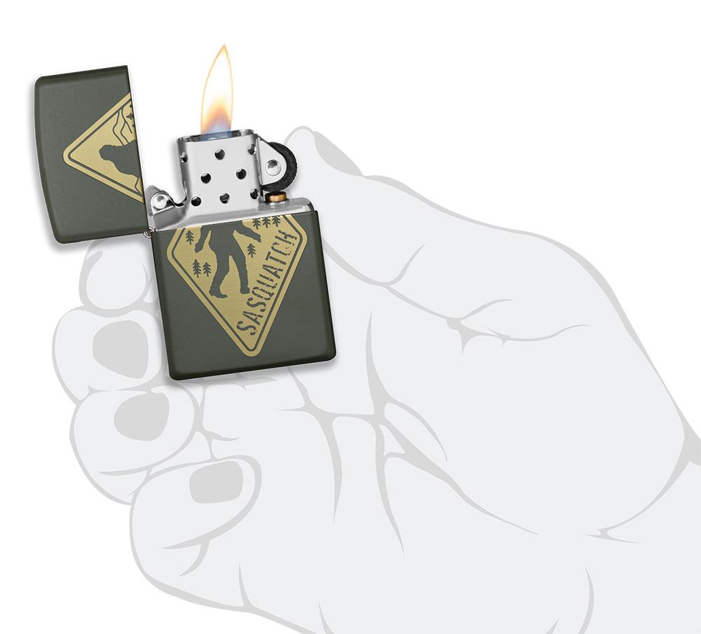 Sasquatch Crossing Windproof Lighter lit in hand
