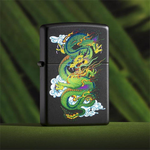 Lifestyle image of Black Matte Dragon Lighter with a green background