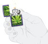 Cannabis Design Texture Print Leaf Purple Matte Windproof Lighter lit in hand.