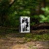 Lifestyle image of Squatchin' In The Woods 360° Design Windproof Lighter standing on a log in the woods
