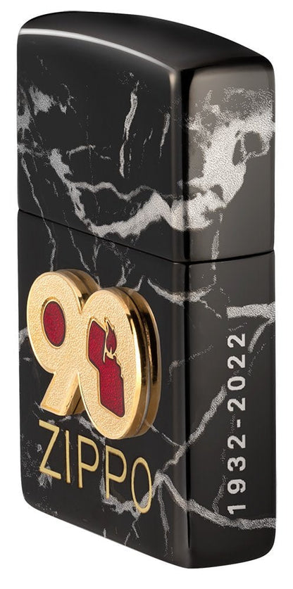 Angled shot of 90th Anniversary "Everyday" Piece Windproof Lighter, showing the front emblem and engraving on the right side.